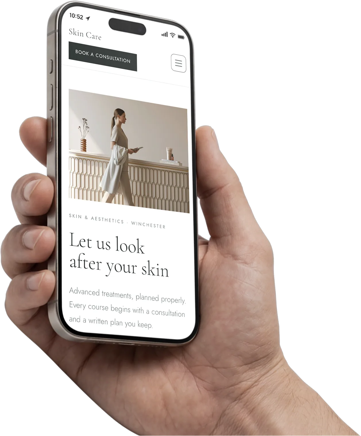 A hand holding a phone showing a skin clinic website